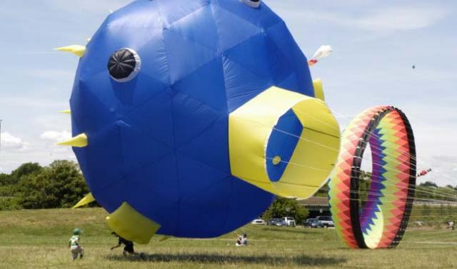 Kites at PJPII Park: The skies above Pope John Paul II Park in Neponset were ablaze with colorful kites and oversized balloons on Saturday, June 13, drawing hundreds of people who picnicked and strolled the walks through river-front oasis. Photo by Bill Forry