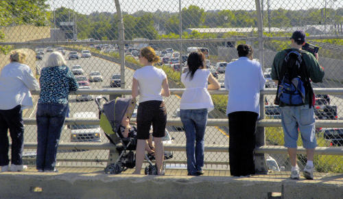 Waiting for the procession: Onlookers gather along the Savin Hill Avenue Bridge in Dorchester to view the funeral cortege. The scene was replicated all along the 75 mile  route form Hyannisport to Boston.