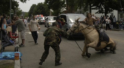 Scary moment: A nervous horse lost its footing near Dorchester Park in Lower Mills during Sunday's parade and fell, knocking its rider to the ground and sending spectators scattering. The horse was led off the parade route and no one was injured. Photo by Bill Forry