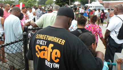 Harambee Park rally: About 50 people turned out for a Tuesday evening rally near the scene of Monday night's shooting of a 4 year-old boy. Photo by Pat Tarantino