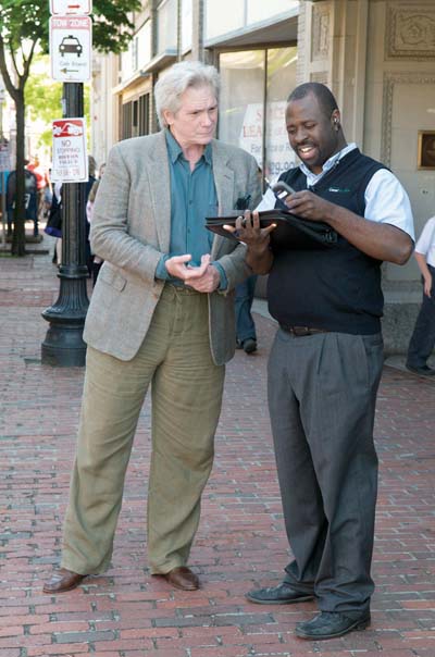 Sean Roberts, left, Jones Hill resident and founder of the Strand Project of the Boston Classical Orchestra, would personally meet each bus of students to usher them into the classical music concerts. Photo courtesy City of Boston