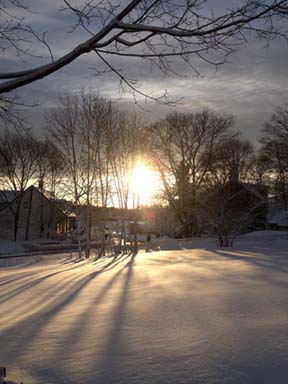 Snow-draped sunset on Sunday: Kenji Quinn snapped this shot from his home near River Street and Central Ave. in Lower Mills.