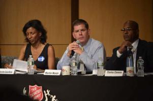 Rep. Martin J. Walsh, center, spoke during a forum at the Kroc Center on Dudley Street on Tuesday evening. He is flanked by candidates Charlotte Golar Richie, left, and Charles Clemons, right. Photo by Eric Esteves