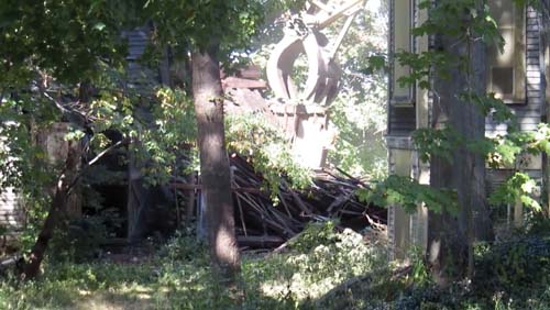 Grampian Way barn: Heavy equipment was brought in to tear down the stable at the rear of 24 Grampian Way on Monday morning. The Savin Hill building was one of two that preservationists sought to protect from demolition by securing landmark status from the city of Boston. The owners secured a demolition permit to take down the stable from the city last week. Photo by Bill Forry