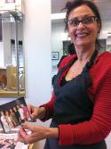 Mary Salas: Hair Image owner holds a photo from the 1980s that shows her with other stylists who worked at the salon. Photo by Bill Forry