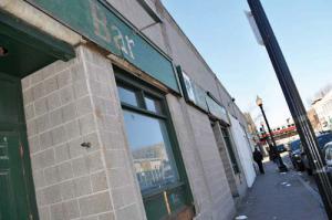 The old Emerald Isle building in Fields Corner is being renovated by new owners. The first new tenant— a T-Mobile store— will move into the building next month. 	Photo by Bill Forry