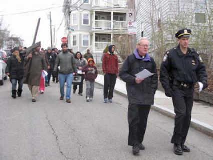 Stations of the Cross: On Good Friday, members of St.Peter’s Parish Via Sacra carried the Cross around the neighborhood to the sites where community members died as a result of acts of violence.                      			                    Photo by David Eisenstadter