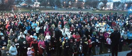 Garvey Park Vigil on April 15, 2014: Fr. Sean Connor, former pastor of St. Ann Church in Neponset, addressed a crowd of some 1,500 people who turned out in the rain at Garvey Park for a vigil to remember Martin Richard and the other victims of last year’s bombings at the Boston Marathon. 	Photo by Bill Forry
