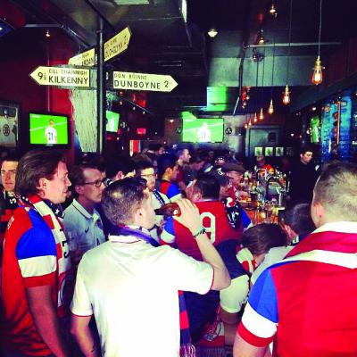 Outlaws and scholars: The Banshee Bar on Dorchester Avenue has become home base for the Boston chapter of the American Outlaws, a club that supports the US soccer team now making a run at the World Cup. Above, the scene in the Banshee on Monday before the US took on Ghana in their first round match. Photo by Michael Ratty