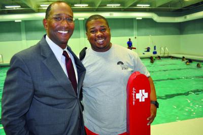 Dot House: Dorchester House President and CEO Walter Ramos is shown, left, with Head Lifeguard Dirk Bovell next to the pool facility which re-opened this week at the Dot House after a $600,000 renovation project. 	Photo by Bill Forry