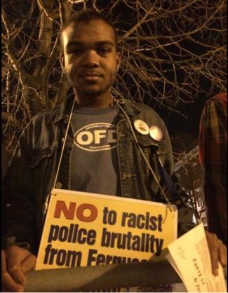 Protestor in Dudley Square: Isaiah Wilkerson, 19, is from Fields Corner and joined a protest march from Dudley Square to South Bay last night. Photo by Lauren Dezenski