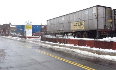 City weighs three proposals to redevelop key parcel: A view of the former Maxwell Box Company property as seen from East Cottage Street. The city of Boston seized control of the site in 2011 and is now seeking offers from private developers to re-use the site. Reporter file photo