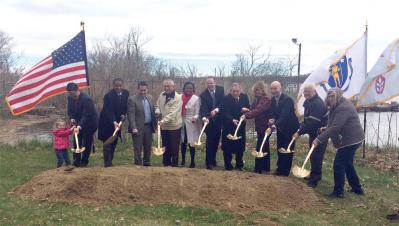 A group of elected officials and Port Norfolk residents, including the city’s Chris Cook and Austin Blackmon, City Councillor Frank Baker, State Sen. Linda Dorcena Forry, DCR Commissioner Jack Murray, Jim Lyons, Mary McCarthy, and State Rep. Dan Hunt gathered at Port Norfolk Park on Thursday for the park’s ceremonial groundbreaking. 	Lauren Dezenski photo