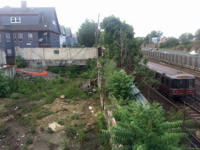 Savin Hole: This prominent “hole” in the Savin Hill business district — right next to the bridge that spans the MBTA tracks and southeast expressway— will soon be replaced with new condominiums and first-floor retail space.  			Bill Forry photo