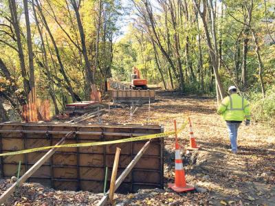 Greenway: Work is proceeding this fall on a 1.3 mile extension of the Neponset River Greenway. Above, a Department of Conservation and Recreation supervisor walked along the trail on the Mattapan side of the Neponset River on Monday. The $14 million segment will be completed next spring, according to current projections. 	Jennifer Smith photo