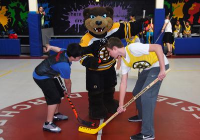 The Boston Bruins and their Mascot, “Blades” visited the Boys &amp;amp;amp; Girls Clubs of Dorchester to host a Clinic for our members. The participants were given a goody bag and the Bruins donated equipment for our Floor Hockey programs.