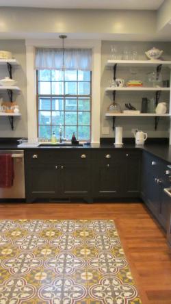 The modern kitchen still features the house's original glass windows