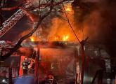 House ablaze on Draper Street, with firefighters on what's left of front porch