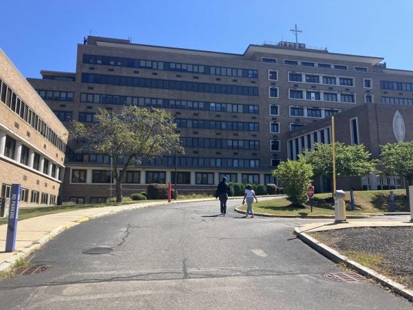 People walked up to the shuttered Carney Hospital on Sept. 3. Alison Kuznitz photo/ SHNS